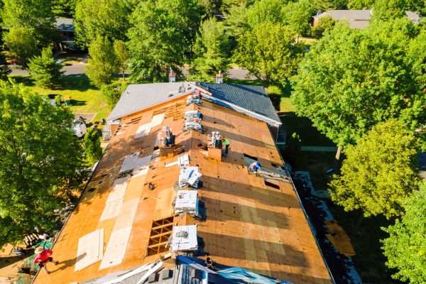 During repair of apartment buildings roof, new shingles were installed and old ones were replaced plywood.